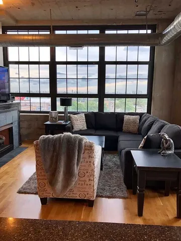 a living room with furniture and a floor to ceiling window