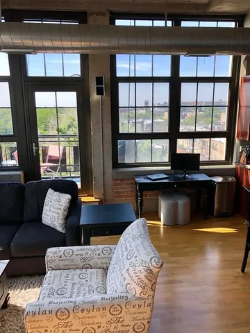 a living room with furniture and large windows