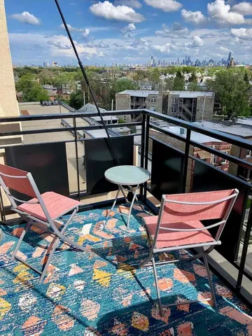 a balcony with table and chairs
