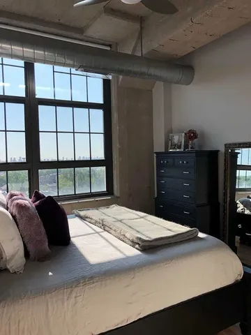 a bedroom with a bed and a dresser