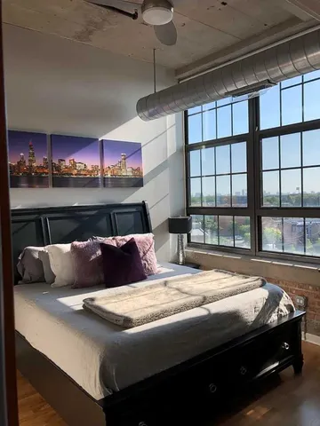 a bed sitting in a bedroom next to a window