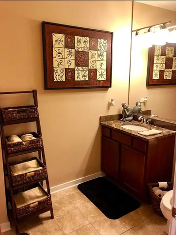 a bathroom with a sink a vanity and a large mirror