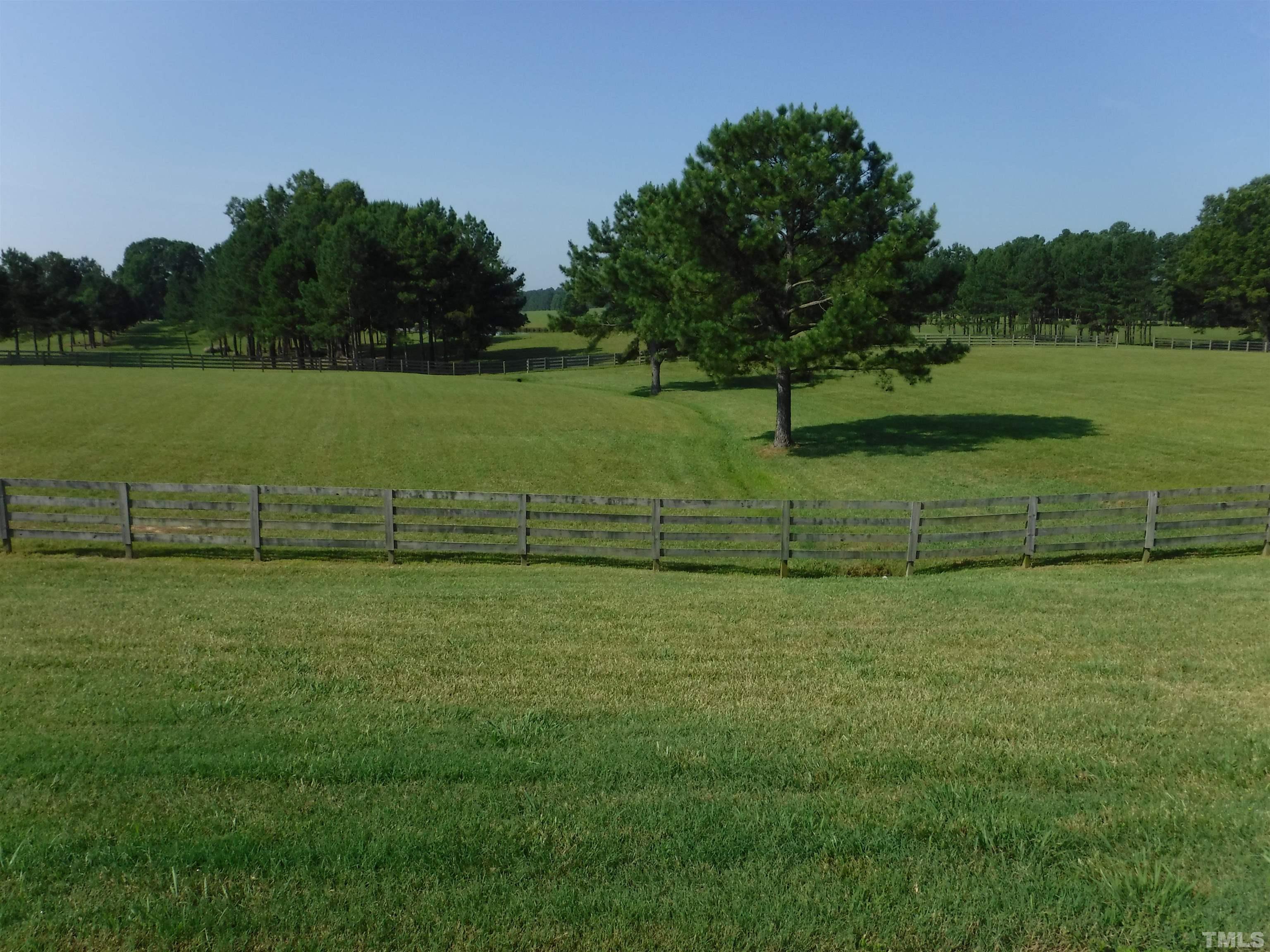 4708 Uzzle Road Rougemont, NC 27572 - Photo 18 of 51 a view of a golf course with a lake