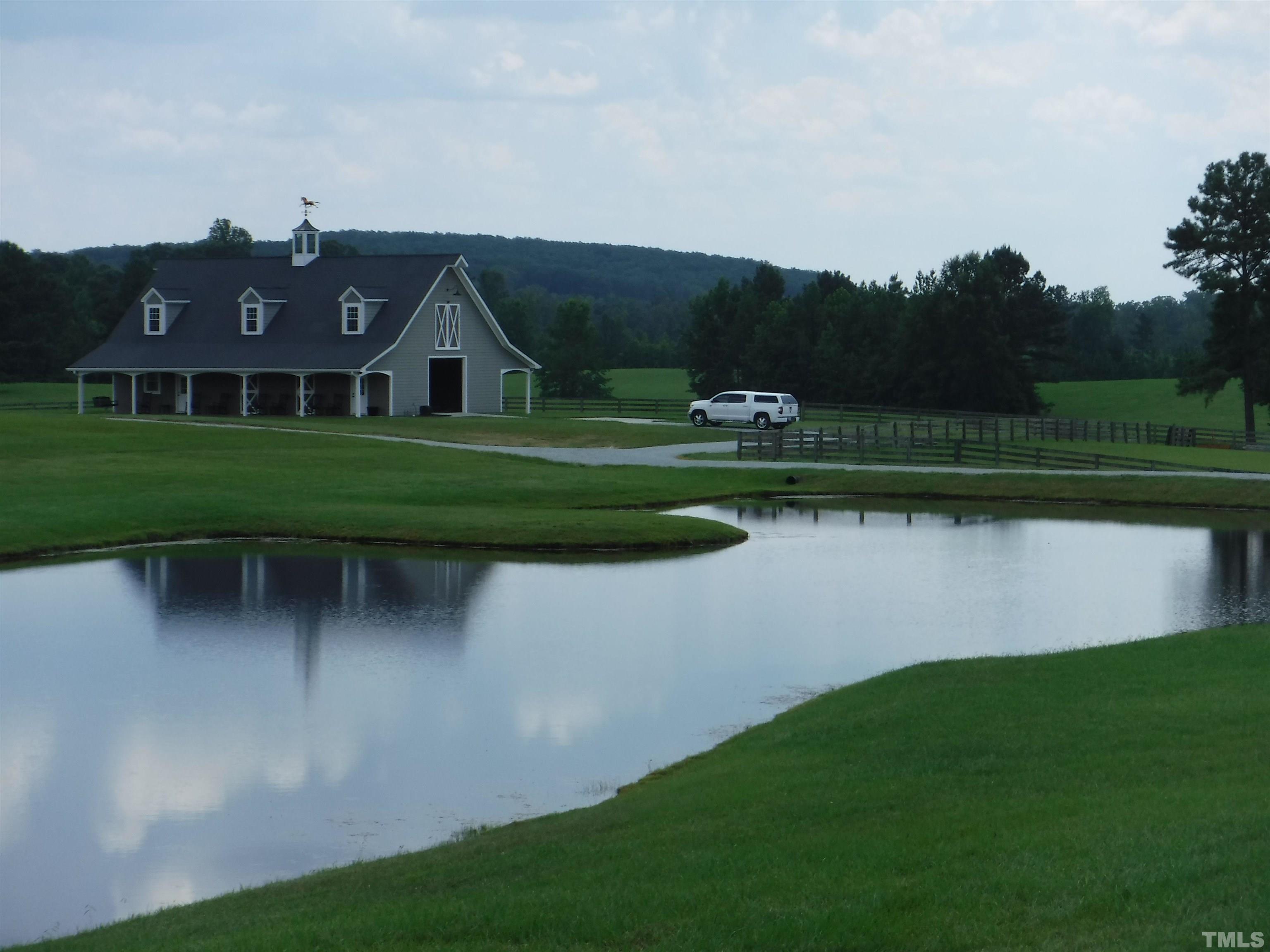 4708 Uzzle Road Rougemont, NC 27572 - Photo 2 of 51 a view of a house with a yard and a fountain