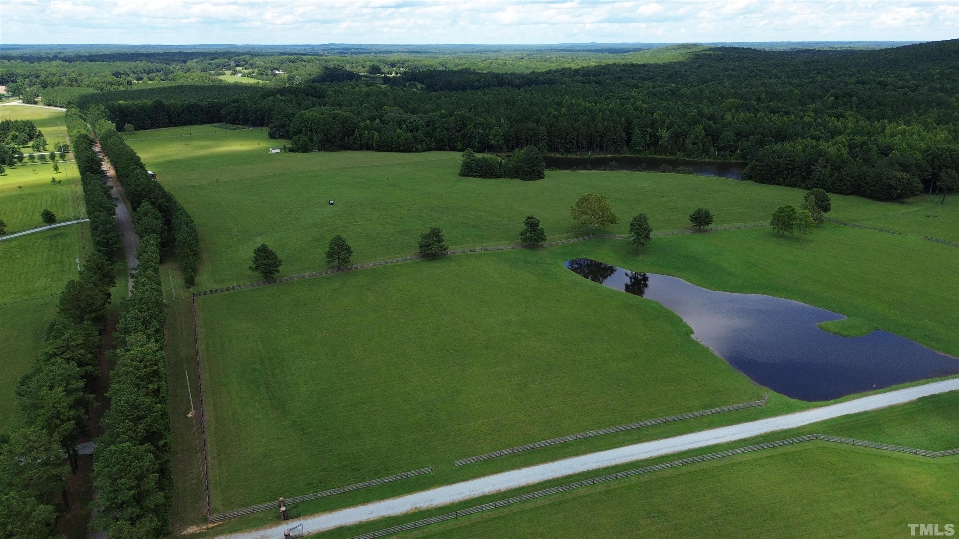 4708 Uzzle Road Rougemont, NC 27572 - Photo 23 of 51 a view of a golf course with a lake
