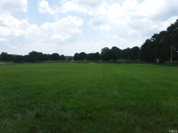 a view of outdoor space with green field and trees