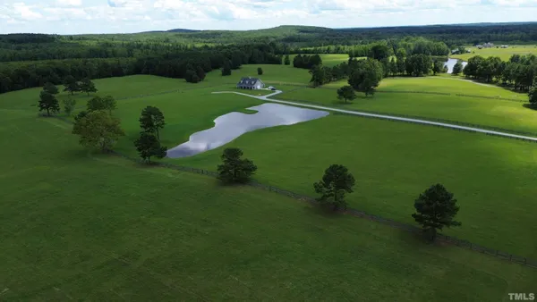 a view of a field with a lake