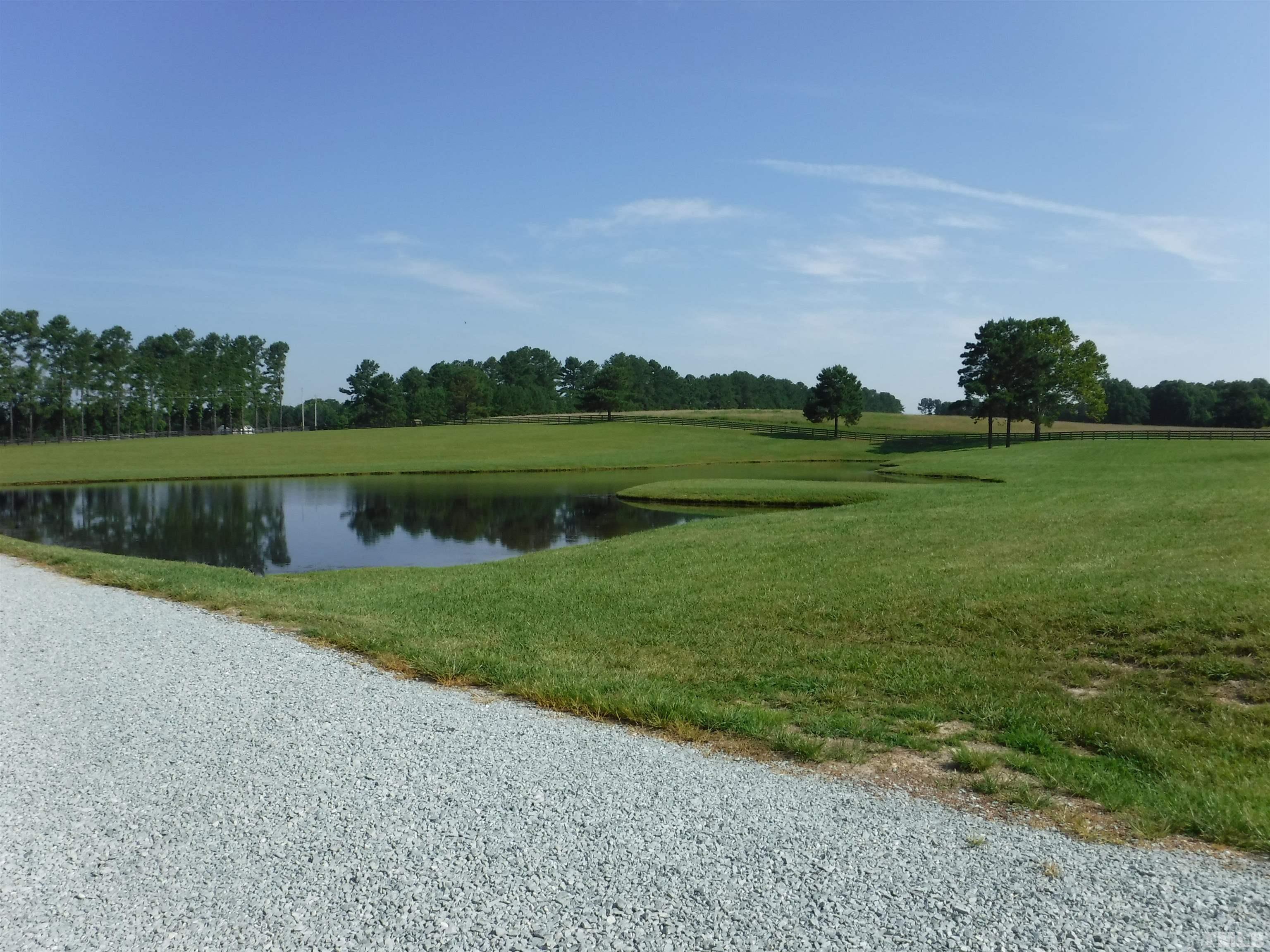 4708 Uzzle Road Rougemont, NC 27572 - Photo 34 of 51 a view of a lake and green valley