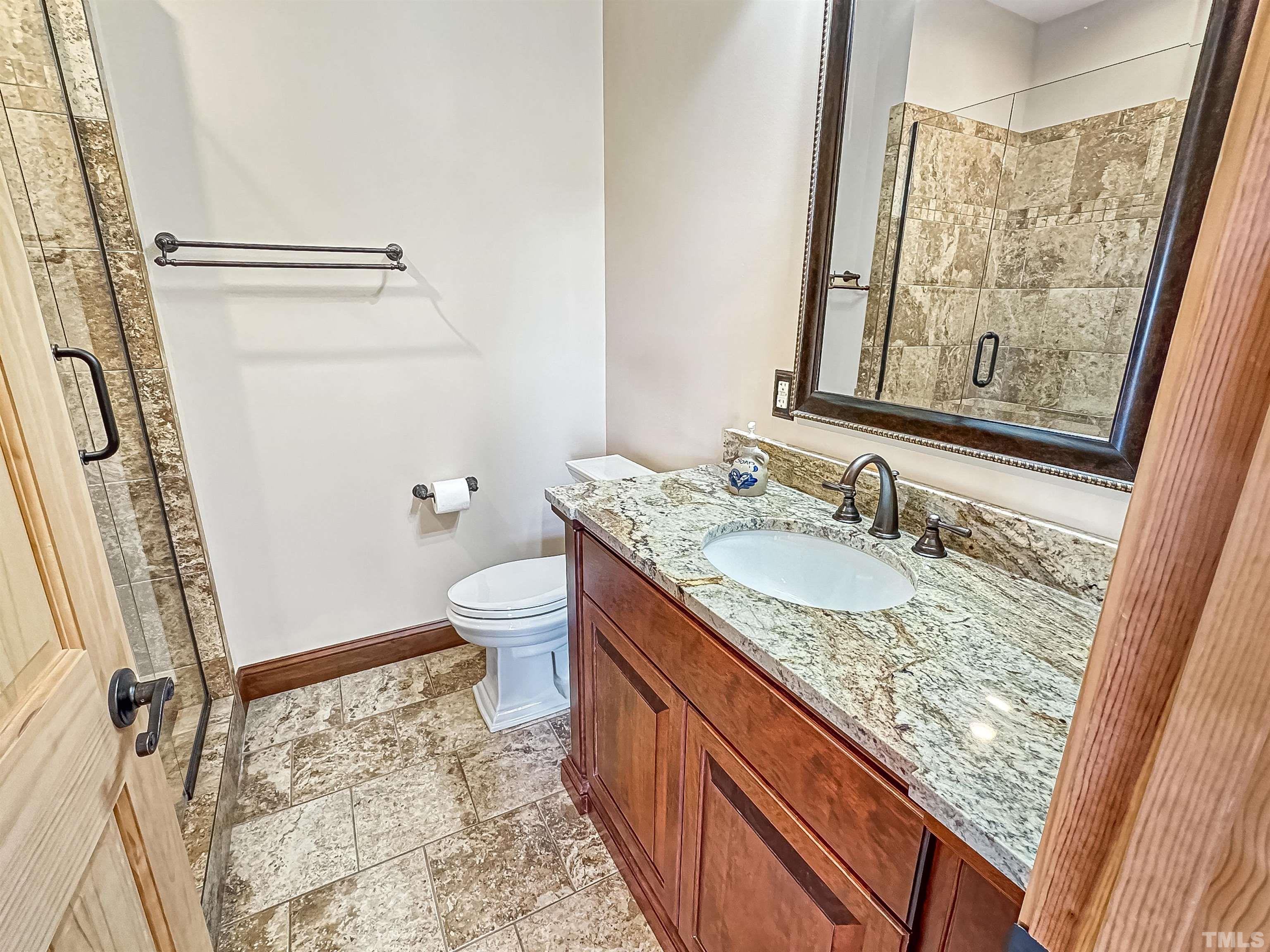 4708 Uzzle Road Rougemont, NC 27572 - Photo 38 of 51 a bathroom with a granite countertop sink and a mirror