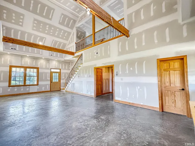 a living room with furniture or stairs and a wooden floor