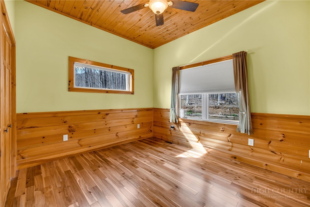 7994 3 Top Road Todd, NC 28684 - Photo 22 of 50 a view of an empty room with wooden floor and a chandelier