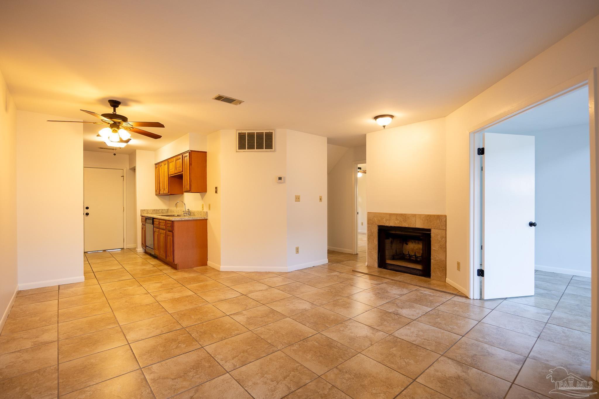 7150 Plantation Road, Unit 312 Pensacola, FL 32504 - Photo 2 of 14 a view of a kitchen with a sink and a fireplace