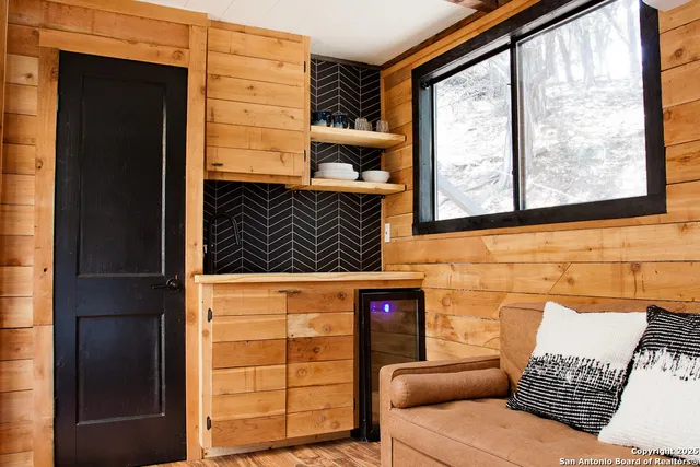 a view of a door of the house with a large window