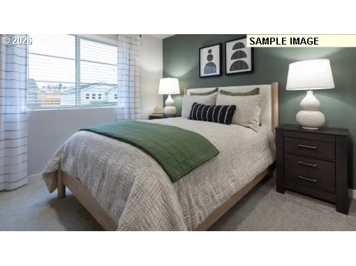 a bedroom with a bed and a lamp