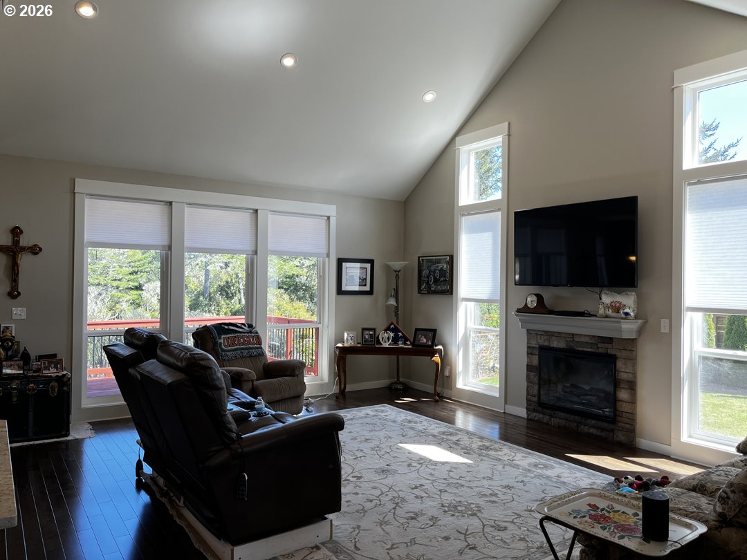 88097 Lake Point Drive Florence, OR 97439 - Photo 11 of 48 a living room with furniture a flat screen tv and a fireplace