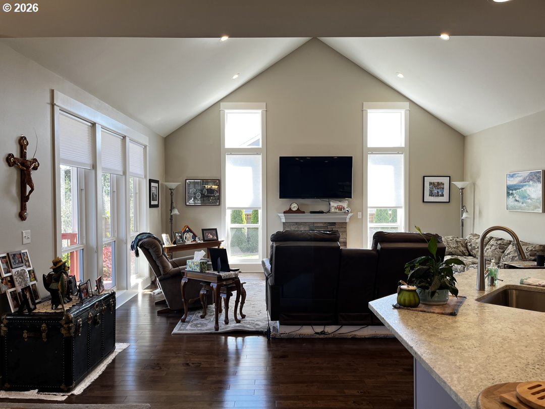 88097 Lake Point Drive Florence, OR 97439 - Photo 13 of 48 a living room with furniture a flat screen tv and kitchen view