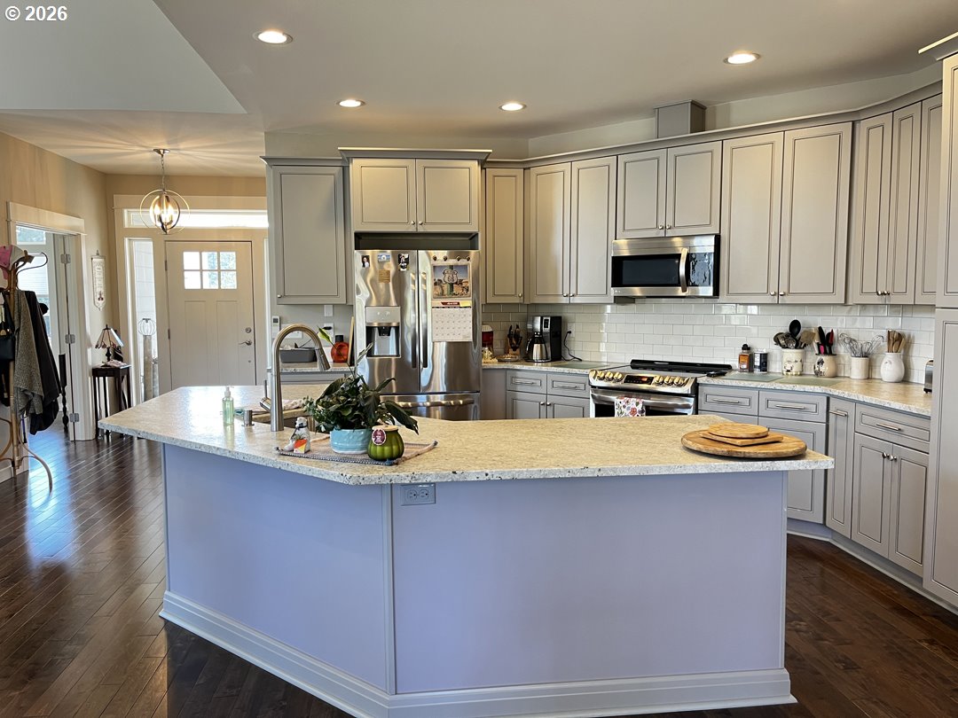 88097 Lake Point Drive Florence, OR 97439 - Photo 16 of 48 a kitchen with stainless steel appliances granite countertop a sink a stove and a wooden floors