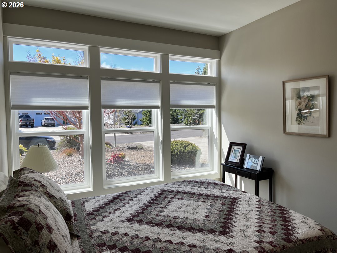 88097 Lake Point Drive Florence, OR 97439 - Photo 24 of 48 a bedroom with a bed and a window