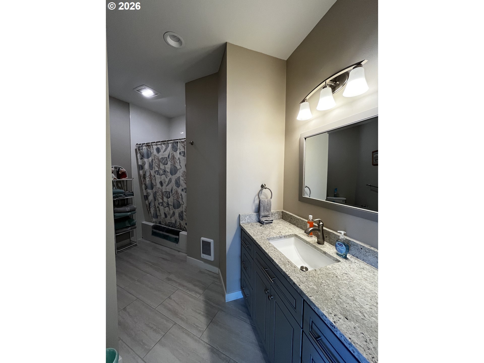 88097 Lake Point Drive Florence, OR 97439 - Photo 26 of 48 a spacious bathroom with a granite countertop sink and a mirror