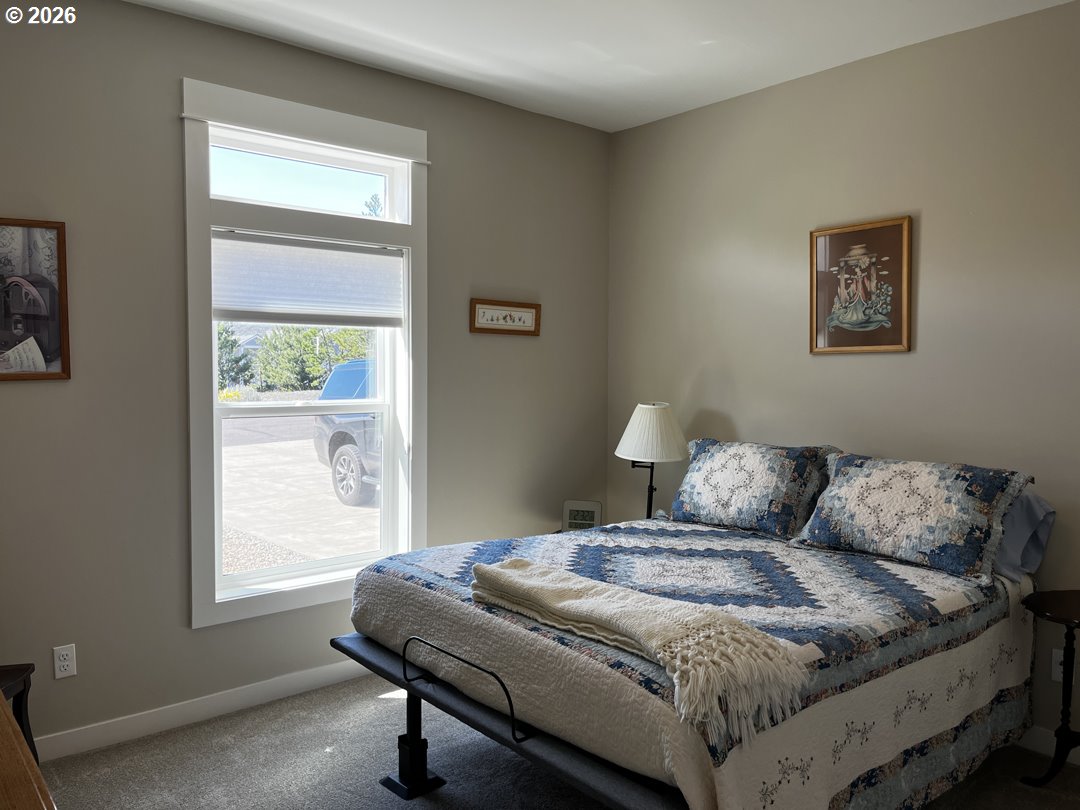 88097 Lake Point Drive Florence, OR 97439 - Photo 28 of 48 a bedroom with a bed and a window
