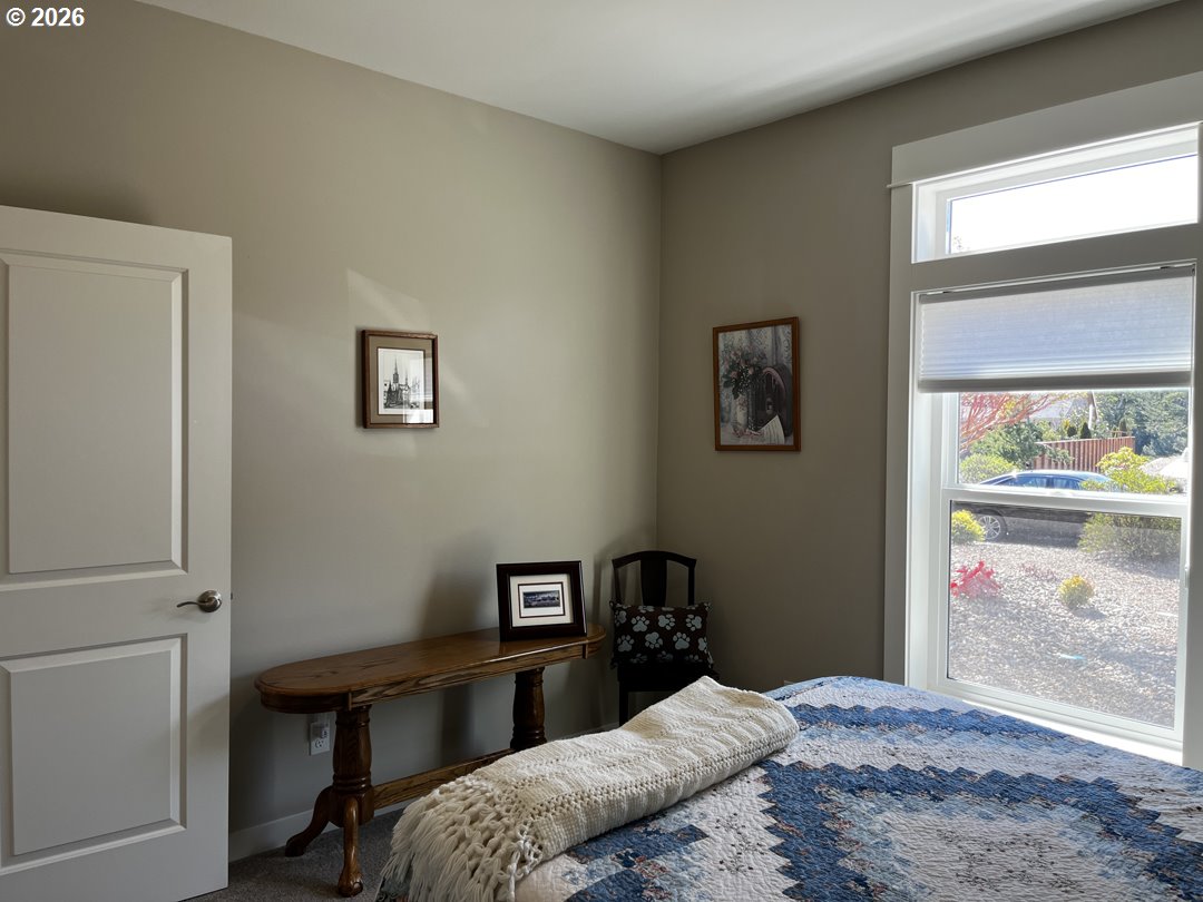 88097 Lake Point Drive Florence, OR 97439 - Photo 29 of 48 a bedroom with a bed and a table in it