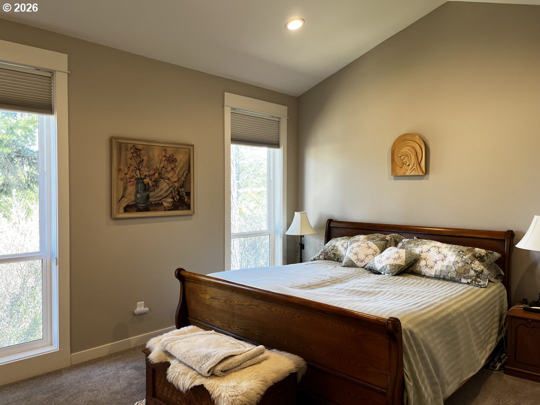 88097 Lake Point Drive Florence, OR 97439 - Photo 33 of 48 a bedroom with a bed and a window