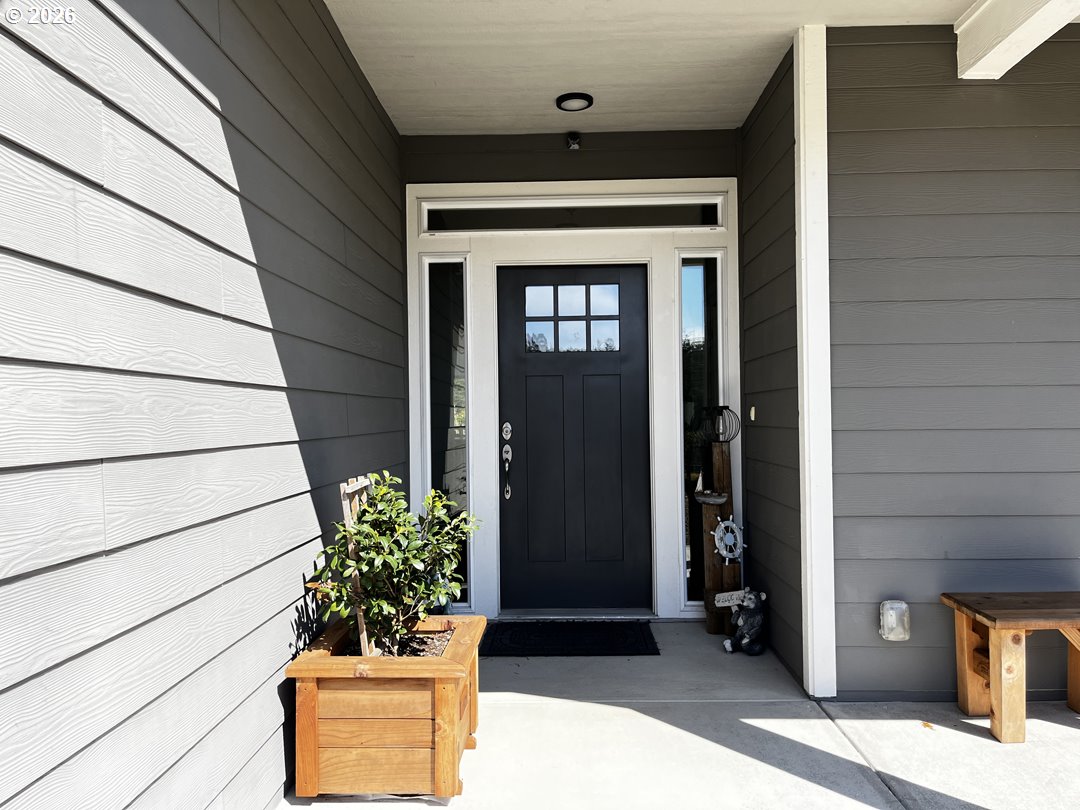 88097 Lake Point Drive Florence, OR 97439 - Photo 6 of 48 a potted plant sitting in front of a door
