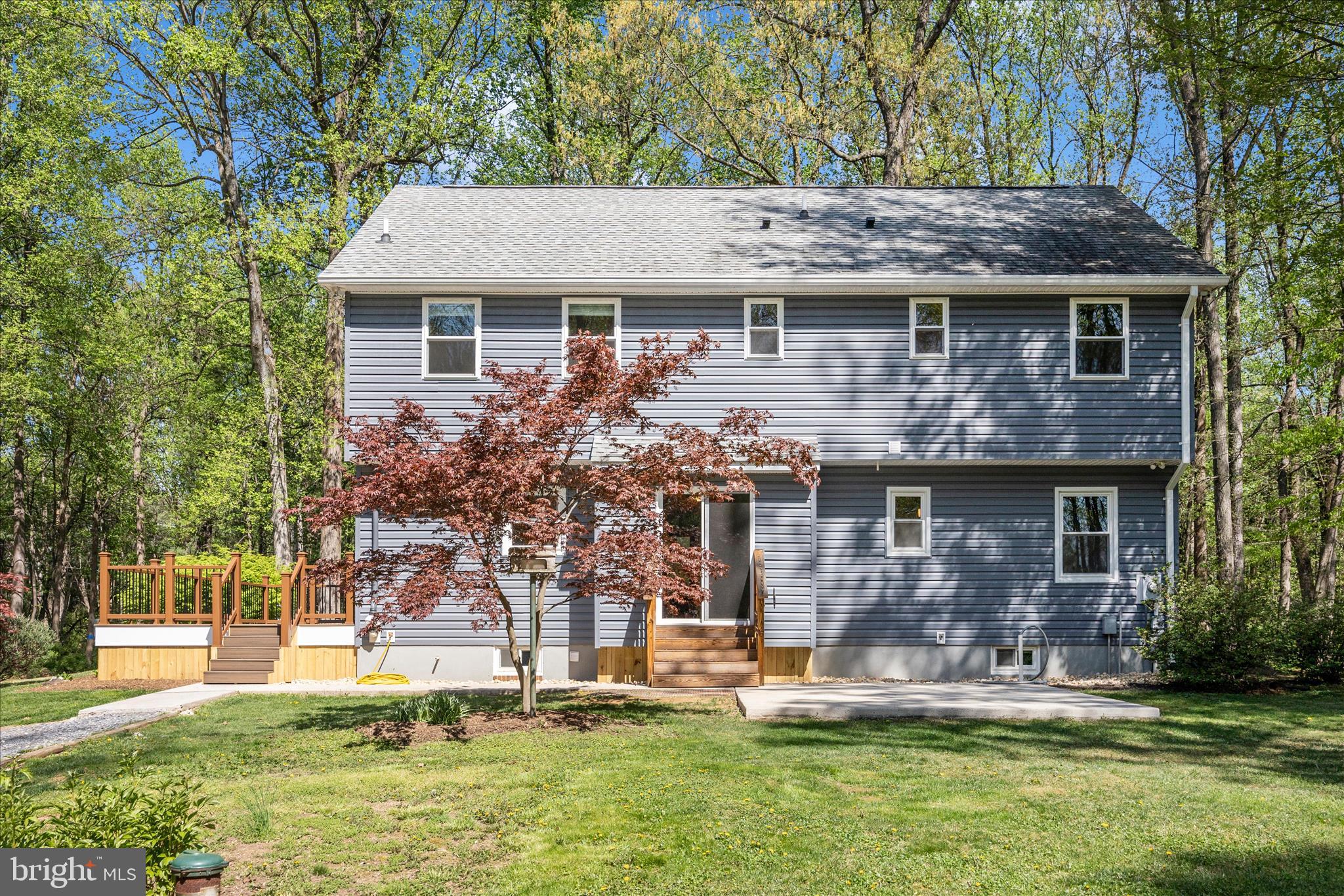6518 Woodville Road Mount Airy, MD 21771 - Photo 41 of 53 a front view of house with a garden and trees