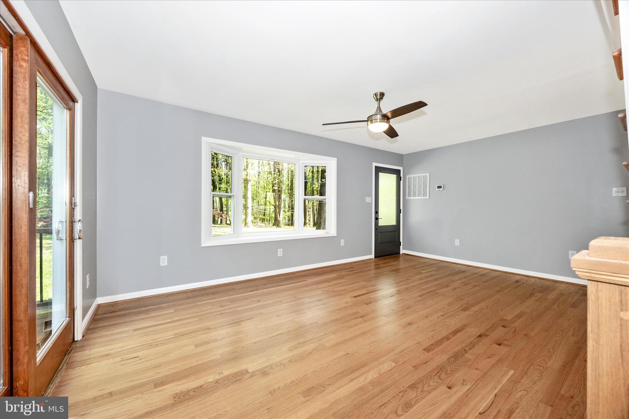 6518 Woodville Road Mount Airy, MD 21771 - Photo 6 of 53 wooden floor in an empty room with a window