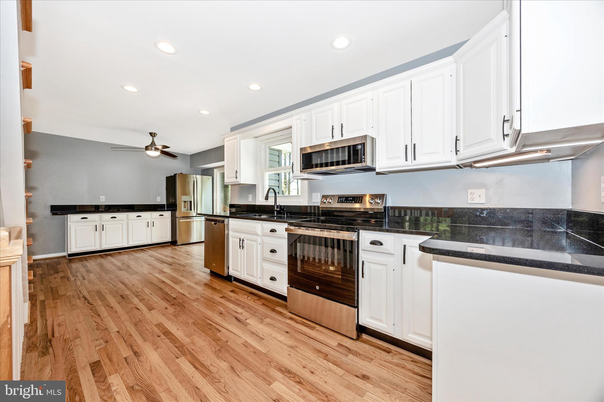 6518 Woodville Road Mount Airy, MD 21771 - Photo 10 of 53 a kitchen with stainless steel appliances granite countertop a stove a sink and a refrigerator