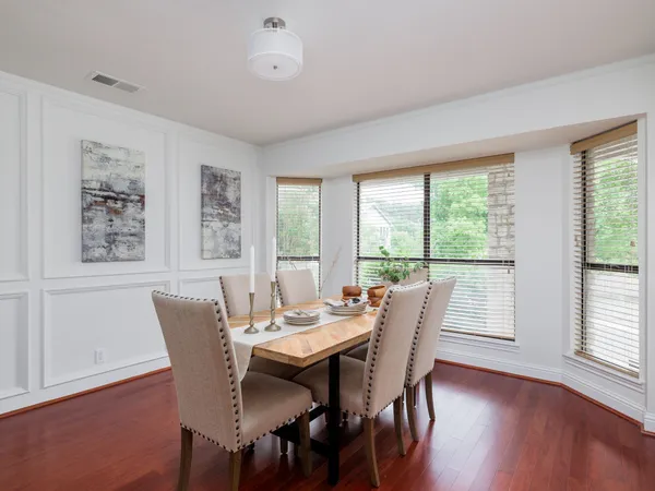 a view of a dining room with furniture and windows