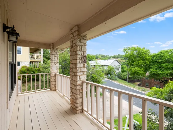a view of a balcony with wooden floor