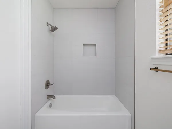 a white bath tub sitting next to a white sink