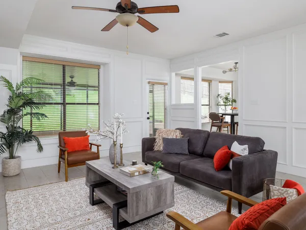 a living room with furniture and a large window