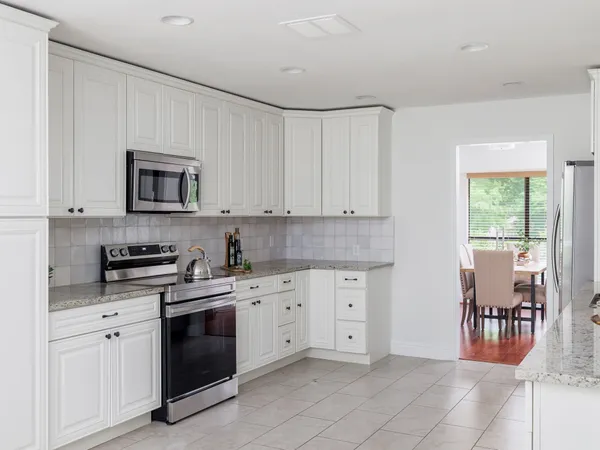 a kitchen with a stove top oven sink and cabinets