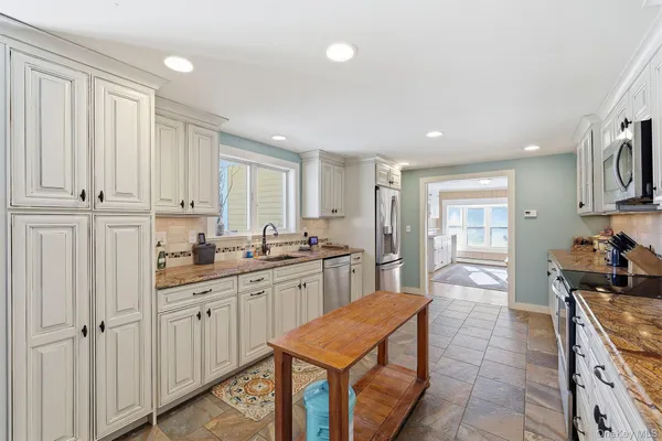 a kitchen with stainless steel appliances granite countertop a sink and cabinets