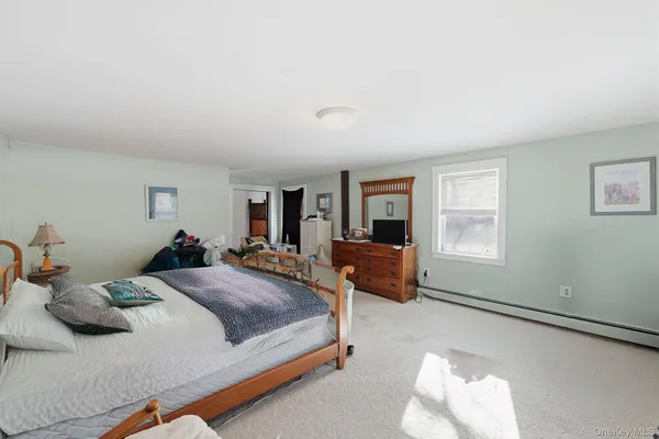 a bedroom with a bed and a large window