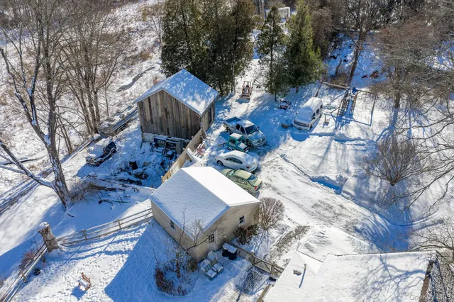 a view of a house with a snow in the yard