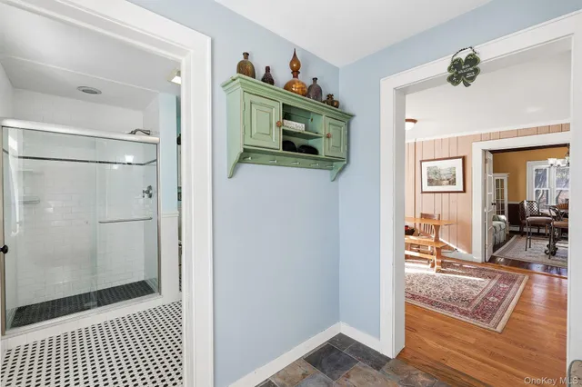 a view of a hallway and a livingroom and a livingroom with furniture