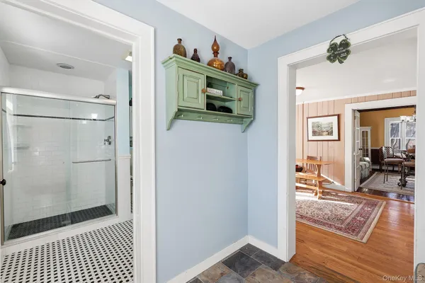 a view of a hallway and a livingroom and a livingroom with furniture