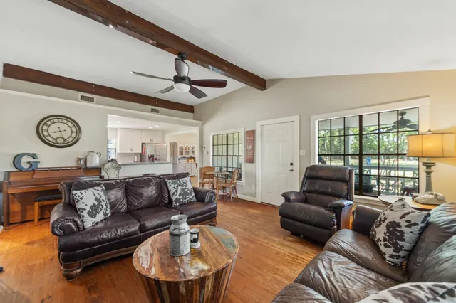 a living room with furniture a fireplace and a large window