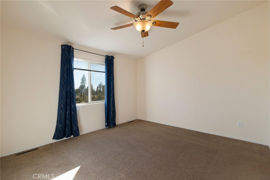 1798 Stearns Road Paradise, CA 95969 - Photo 11 of 39 an empty room with a window and a fan