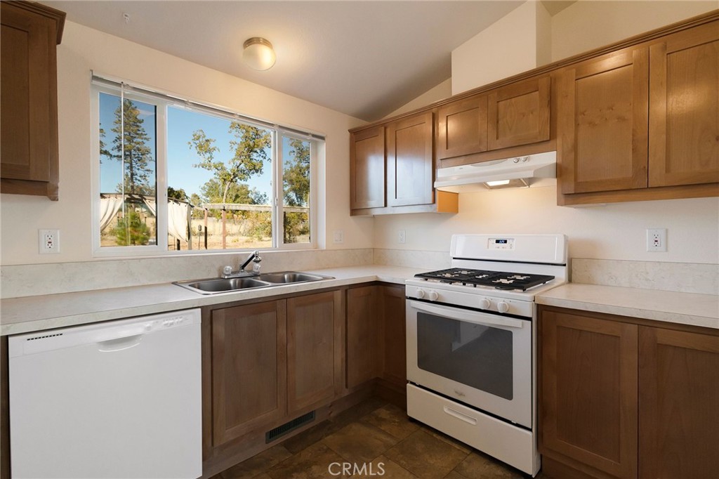 1798 Stearns Road Paradise, CA 95969 - Photo 7 of 39 a kitchen with a stove a sink and a window