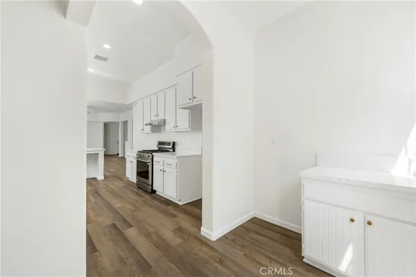 a kitchen with a refrigerator and a stove top oven