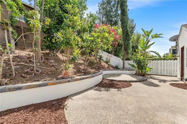 a view of a yard with wooden fence