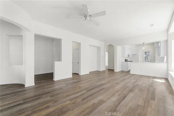 a view of empty room with wooden floor and window