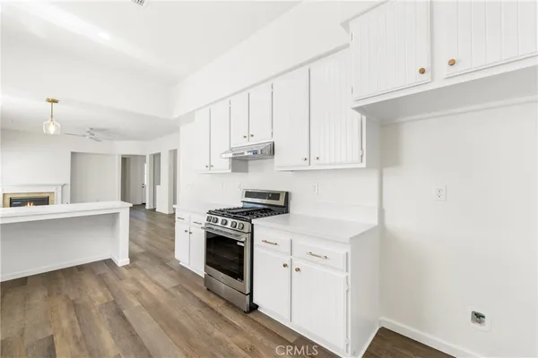 a kitchen with white cabinets and white appliances