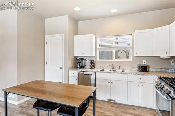 a kitchen with a stove a sink and a refrigerator