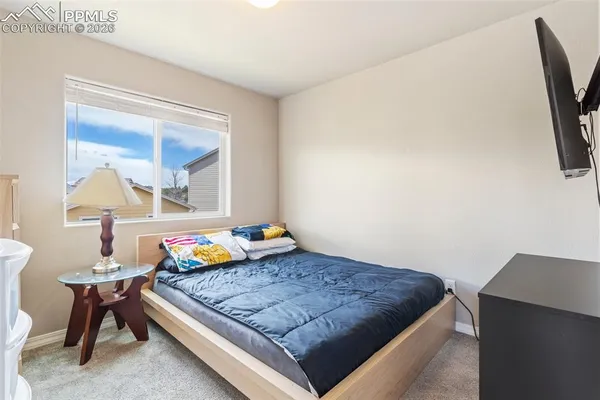 a bedroom with a bed and a chair in it