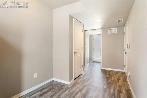 a view of a hallway with wooden floor